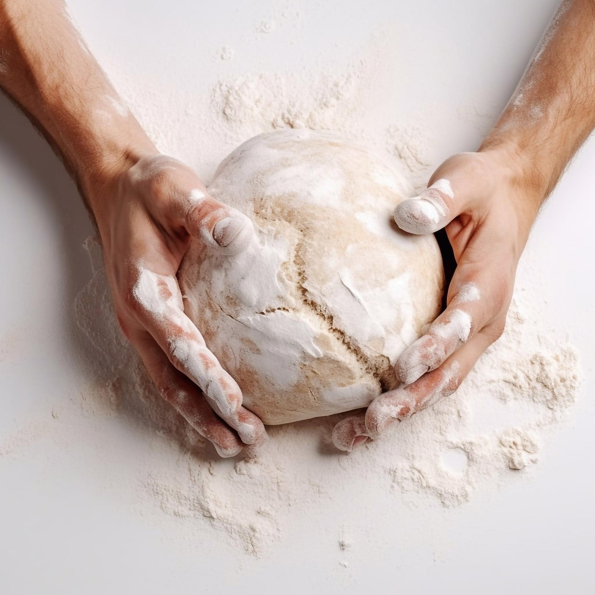 Close-up of hands shaping dough